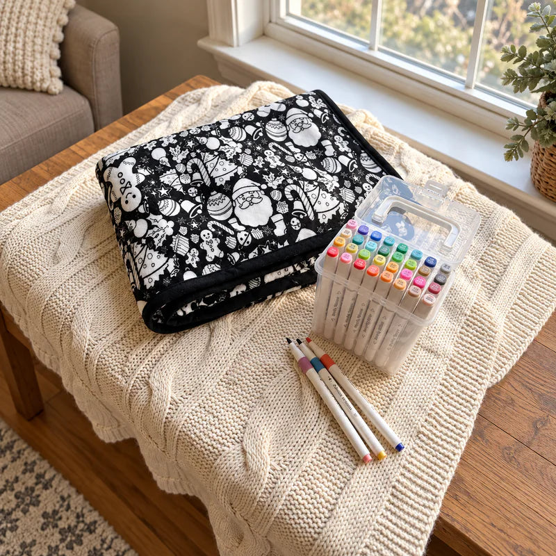 Folded Christmas coloring blanket and markers